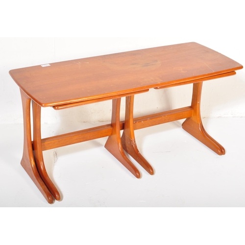 1207 - A mid century teak wood nest of tables. Each with graduating tops having shaped and splayed legs uni... 