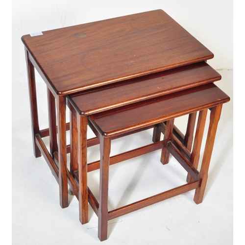 1207 - A mid century teak wood nest of tables. Each with graduating tops having shaped and splayed legs uni... 