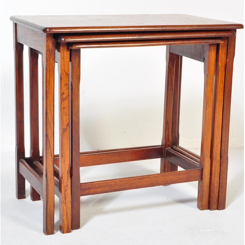 1207 - A mid century teak wood nest of tables. Each with graduating tops having shaped and splayed legs uni... 