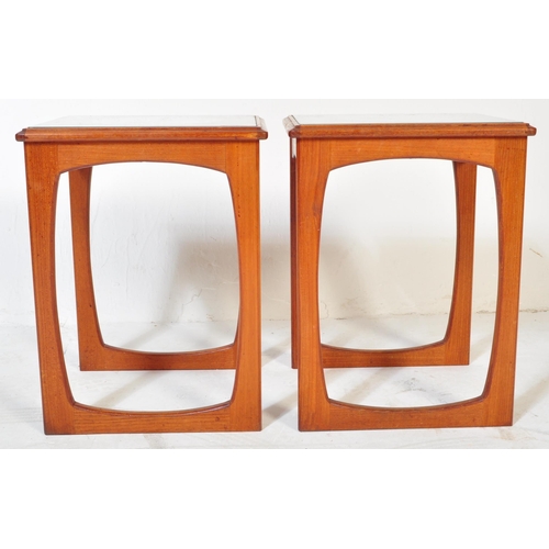 1220 - A pair of vintage retro mid 20th century teak side tables. Each having glazed top with white underla... 