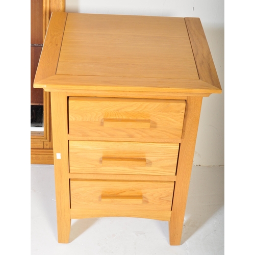 1221 - A contemporary oak bedside chest of drawers in the manner of Oak furniture Land  Raised on squared l... 