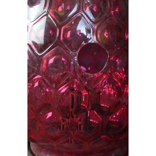 1226 - A vintage retro mid 20th century oil lamp having globular moulded cranberry glass shade over twin ha... 