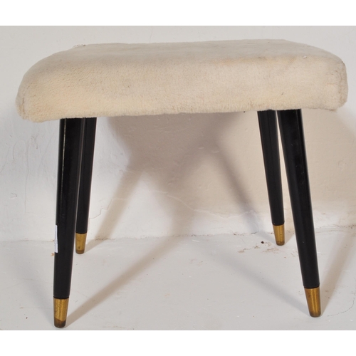 1228 - A Mid-century faux woollen upholstered ottoman footstool. Raised on ebonised tapering dansette style... 