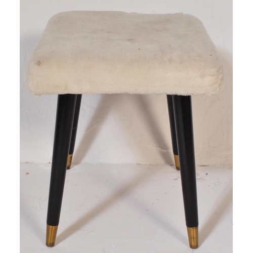 1228 - A Mid-century faux woollen upholstered ottoman footstool. Raised on ebonised tapering dansette style... 