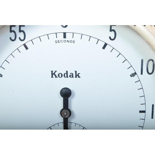 1232 - Kodak - A vintage retro mid 20th century Kodak wall mounted and table top clock of circular form in ... 