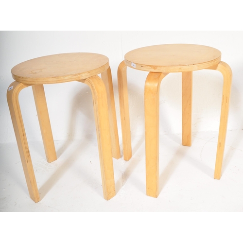 1247 - A set of four retro vintage 20th Century light bentwood wood stacking stools of circular form with b... 