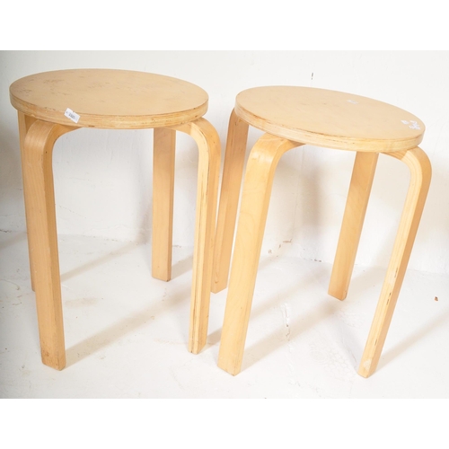 1247 - A set of four retro vintage 20th Century light bentwood wood stacking stools of circular form with b... 