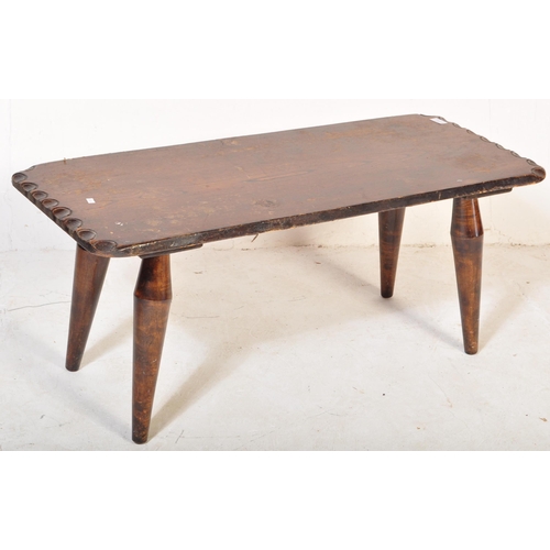 1250 - Mid Century Arts & Crafts, Devon, England. Stained pine coffee table with carved edge over bulbous l... 