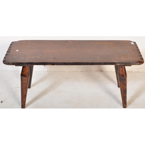 1250 - Mid Century Arts & Crafts, Devon, England. Stained pine coffee table with carved edge over bulbous l... 