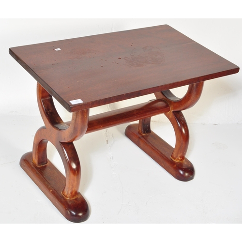 1251 - A vintage 20th Century mahogany hardwood coffee table. Of rectangular form with spanner look semi ci... 