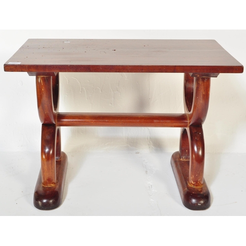 1251 - A vintage 20th Century mahogany hardwood coffee table. Of rectangular form with spanner look semi ci... 