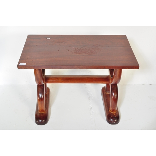 1251 - A vintage 20th Century mahogany hardwood coffee table. Of rectangular form with spanner look semi ci... 