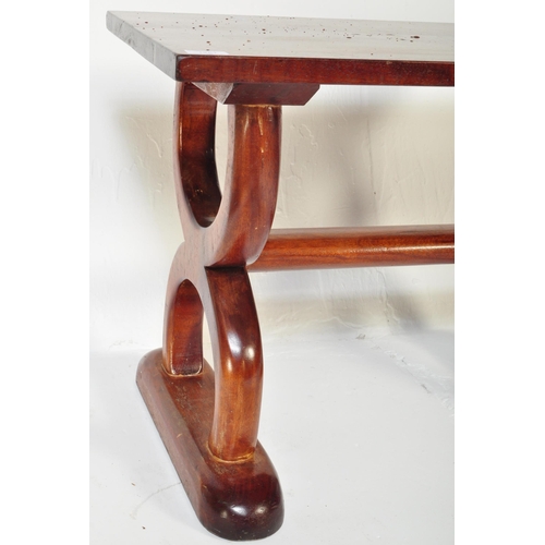 1251 - A vintage 20th Century mahogany hardwood coffee table. Of rectangular form with spanner look semi ci... 