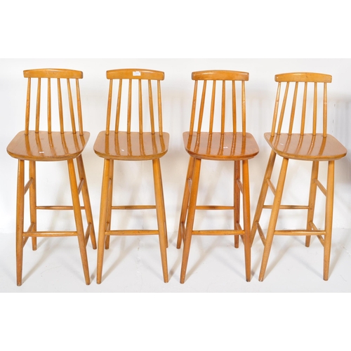 1253 - A set of four retro vintage mid 20th Century Ercol style bar stools light wood chamfered dowel legs,... 