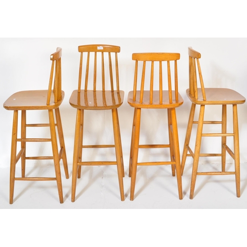 1253 - A set of four retro vintage mid 20th Century Ercol style bar stools light wood chamfered dowel legs,... 