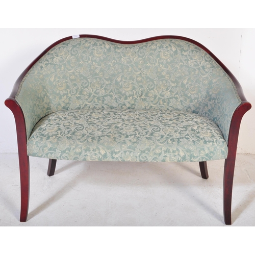 1274 - A retro vintage 20th century upholstered mahogany two seater sofa having a camel back over a aqua gr... 