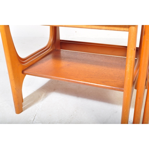 1284 - A mid-century teak wood Danish manner nest of tables. Raised on shaped supports with returns, each w... 