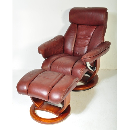 1289 - A vintage 20th Century burgundy leather reclining swivel armchair. With head rest to top straight ar... 