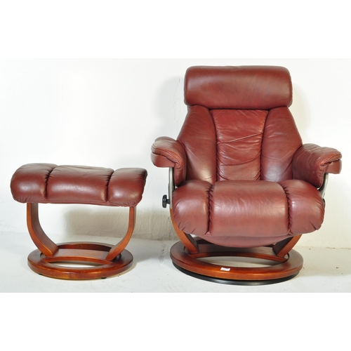 1289 - A vintage 20th Century burgundy leather reclining swivel armchair. With head rest to top straight ar... 