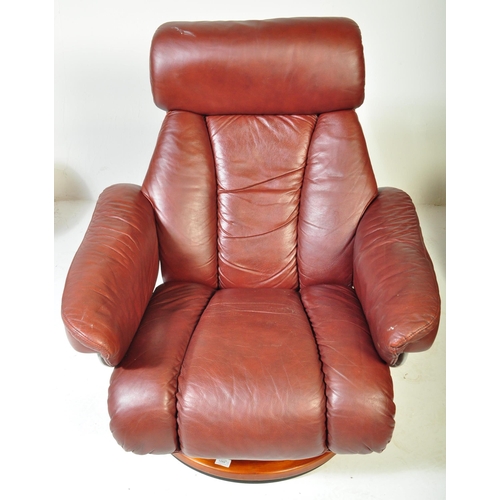 1289 - A vintage 20th Century burgundy leather reclining swivel armchair. With head rest to top straight ar... 