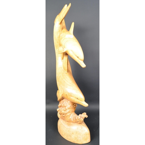 1324 - A vintage 20th Century carved wood sculpture of dolphins. Depicting dolphins swimming with coral ree... 