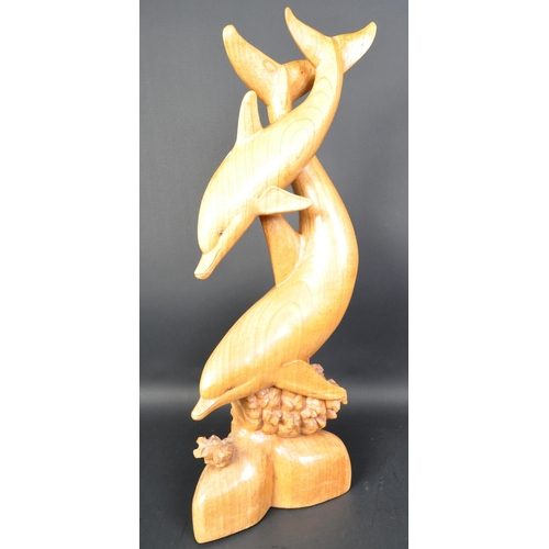 1324 - A vintage 20th Century carved wood sculpture of dolphins. Depicting dolphins swimming with coral ree... 