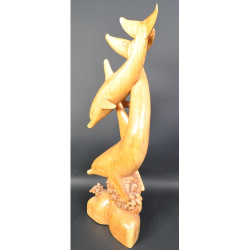 1324 - A vintage 20th Century carved wood sculpture of dolphins. Depicting dolphins swimming with coral ree... 