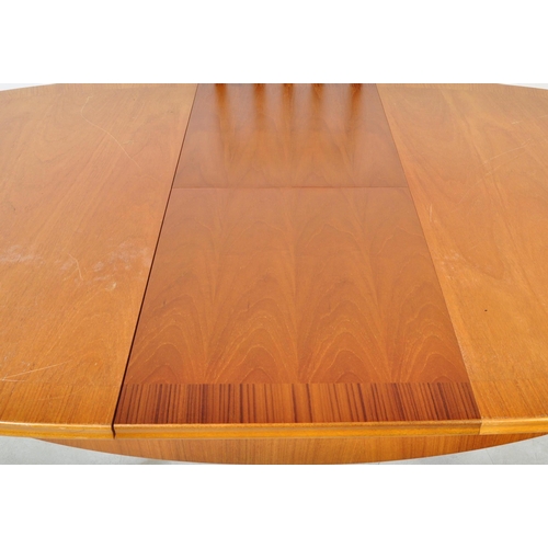 1325 - William Lawrence - A retro vintage mid 20th Century teak extended dining table and chairs. Of oval f... 