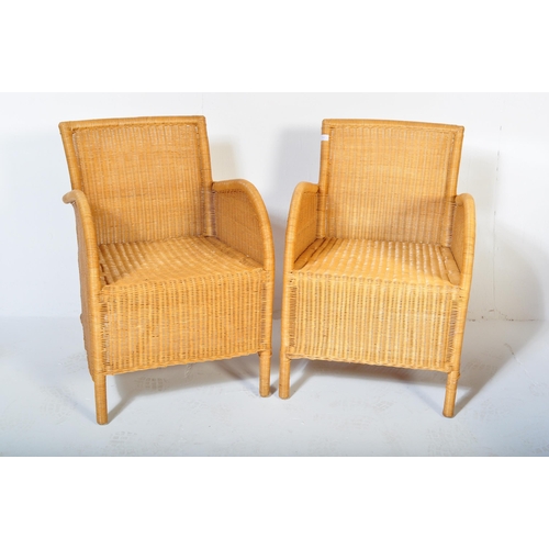 1331 - A pair of retro 20th century wicker / rattan weave armchairs. Shaped arms with fan backs, rattan wea... 