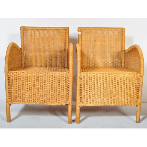 1331 - A pair of retro 20th century wicker / rattan weave armchairs. Shaped arms with fan backs, rattan wea... 