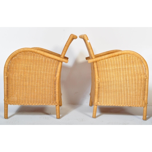 1331 - A pair of retro 20th century wicker / rattan weave armchairs. Shaped arms with fan backs, rattan wea... 