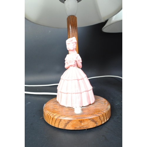 1335 - A pair of 1930's Art Deco oak and crinoline lady porcelain figurine table lamps - Lights. Oak uprigh... 