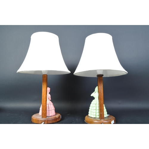 1335 - A pair of 1930's Art Deco oak and crinoline lady porcelain figurine table lamps - Lights. Oak uprigh... 