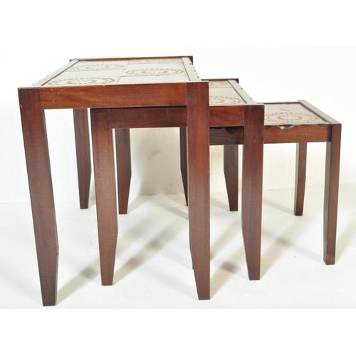 1337 - A Mid century Danish inspired 20th century teak wood and tile top nest of tables. Raised on tapering... 