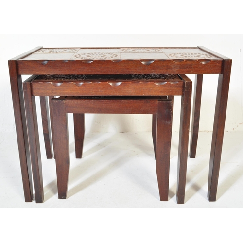 1337 - A Mid century Danish inspired 20th century teak wood and tile top nest of tables. Raised on tapering... 