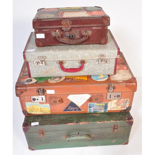 1369 - A stack of four vintage retro 20th century leather travel suitcases in a variety of sizes and colour... 