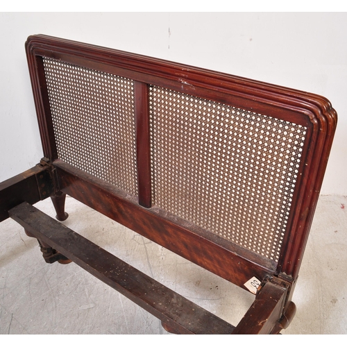 1422 - An early 20th Century Bergere mahogany bed frames. Having a curved threaded frame around cane / wick... 