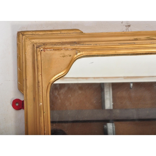 1451 - A large 19th century late Victorian gilt mirror having moulded gilded frame with relief decoration t... 