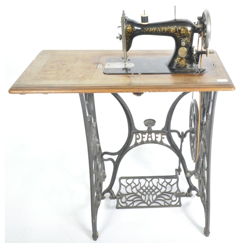 1467 - 19th century mahogany Pfaff sewing machine table. Raised on cast iron treadle base with machine atop... 