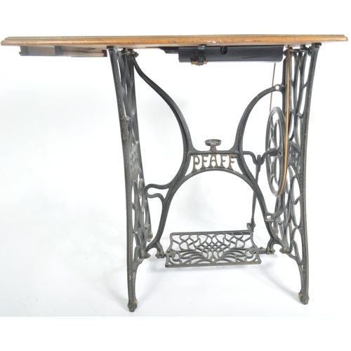 1467 - 19th century mahogany Pfaff sewing machine table. Raised on cast iron treadle base with machine atop... 