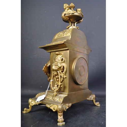 1475 - A 20th century French Louis XIV style gilt brass table mantel clock having a top finial with harpies... 