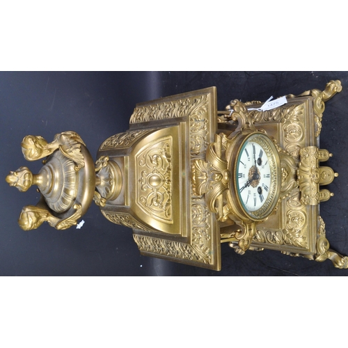 1475 - A 20th century French Louis XIV style gilt brass table mantel clock having a top finial with harpies... 