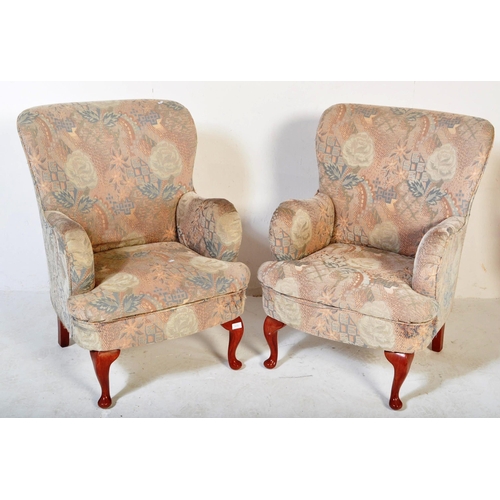 1479 - A pair of mid Century retro armchairs in the Queen Anne revival manner being raised on cabriole legs... 