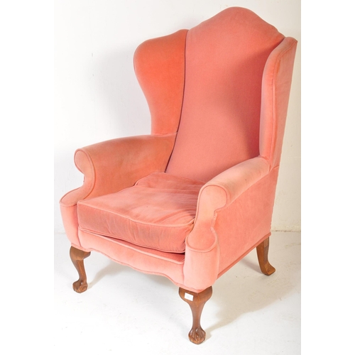 1481 - Queen Anne revival mahogany wing back armchair. The chair being raised on cabriole legs with pad fee... 