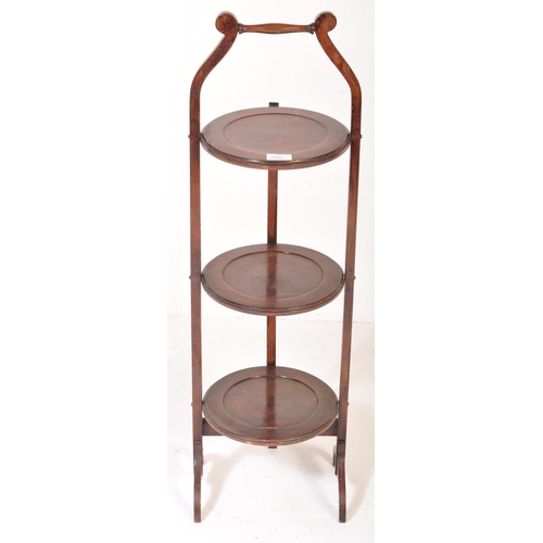 1485 - An early 20th Century circa 1920's mahogany folding cake stand. Having an carry handle to top, three... 