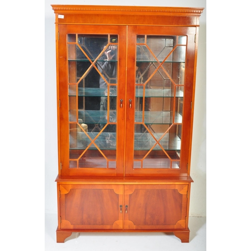 1490 - A 20th century George III revival yew wood veneer China display cabinet. The cabinet having a pedime... 