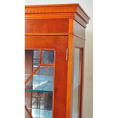 1490 - A 20th century George III revival yew wood veneer China display cabinet. The cabinet having a pedime... 