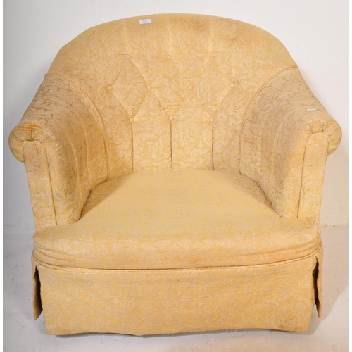 1491 - An early 20th century tub chair / arm chair upholstered in a yellow floral fabric. The chair having ... 