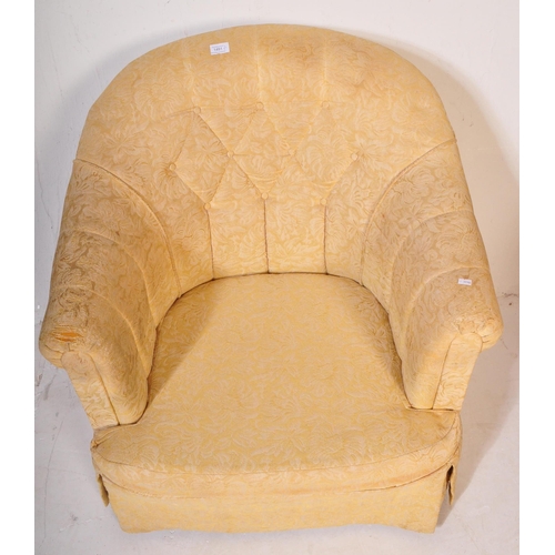 1491 - An early 20th century tub chair / arm chair upholstered in a yellow floral fabric. The chair having ... 