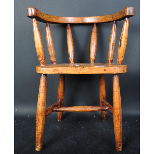 1495 - A early 20th Century elm wood children's chair stool. Having a horseshoe back, with spindles on an o... 